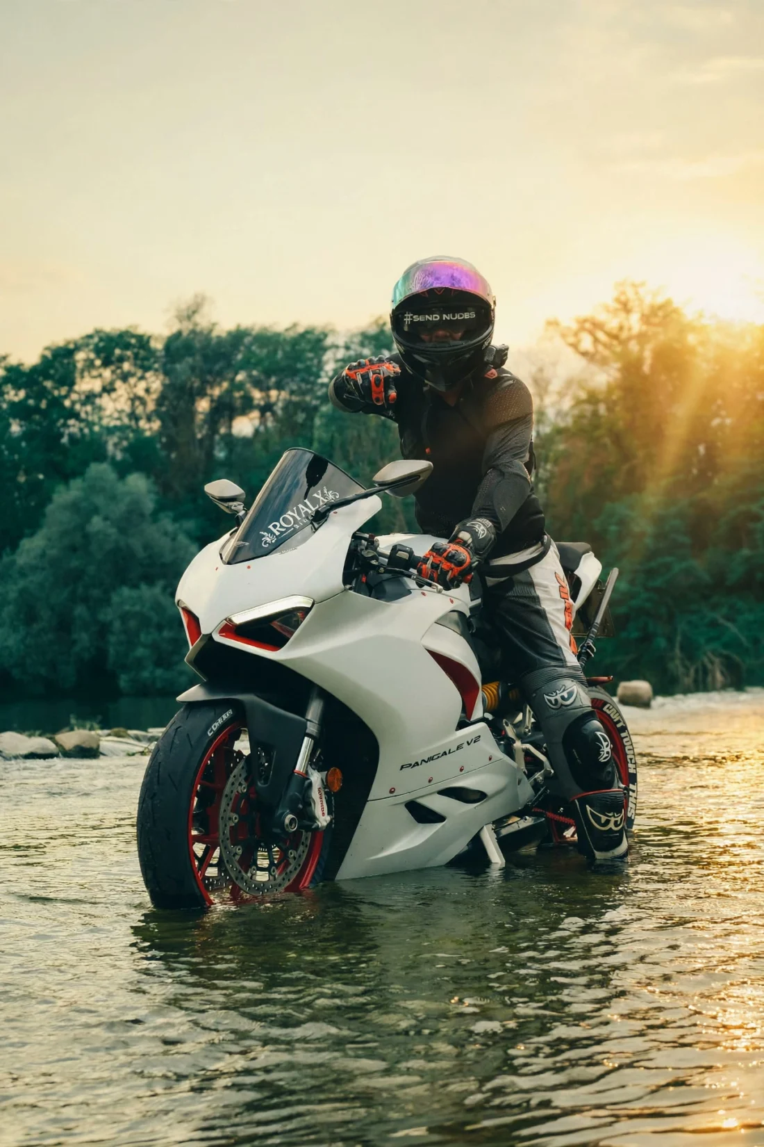 Rider reaching out at sunset