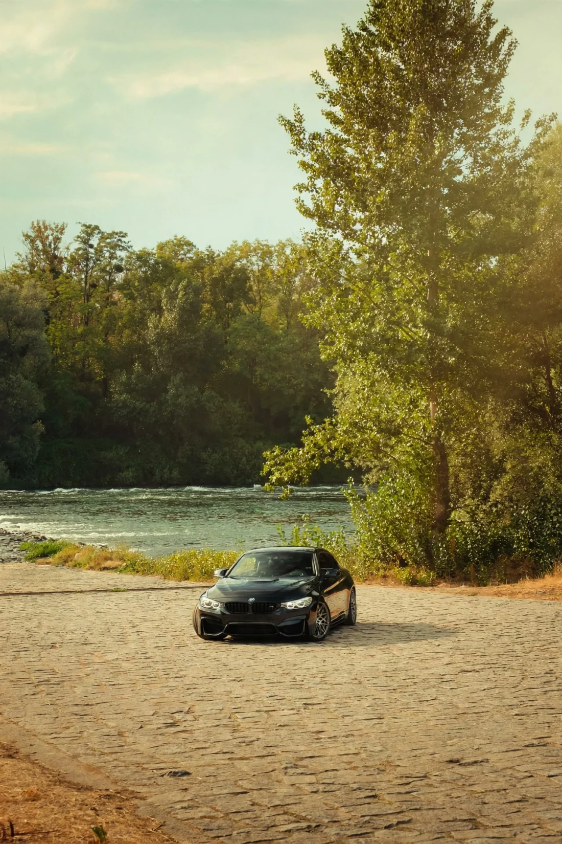 Black M4 from afar by the river